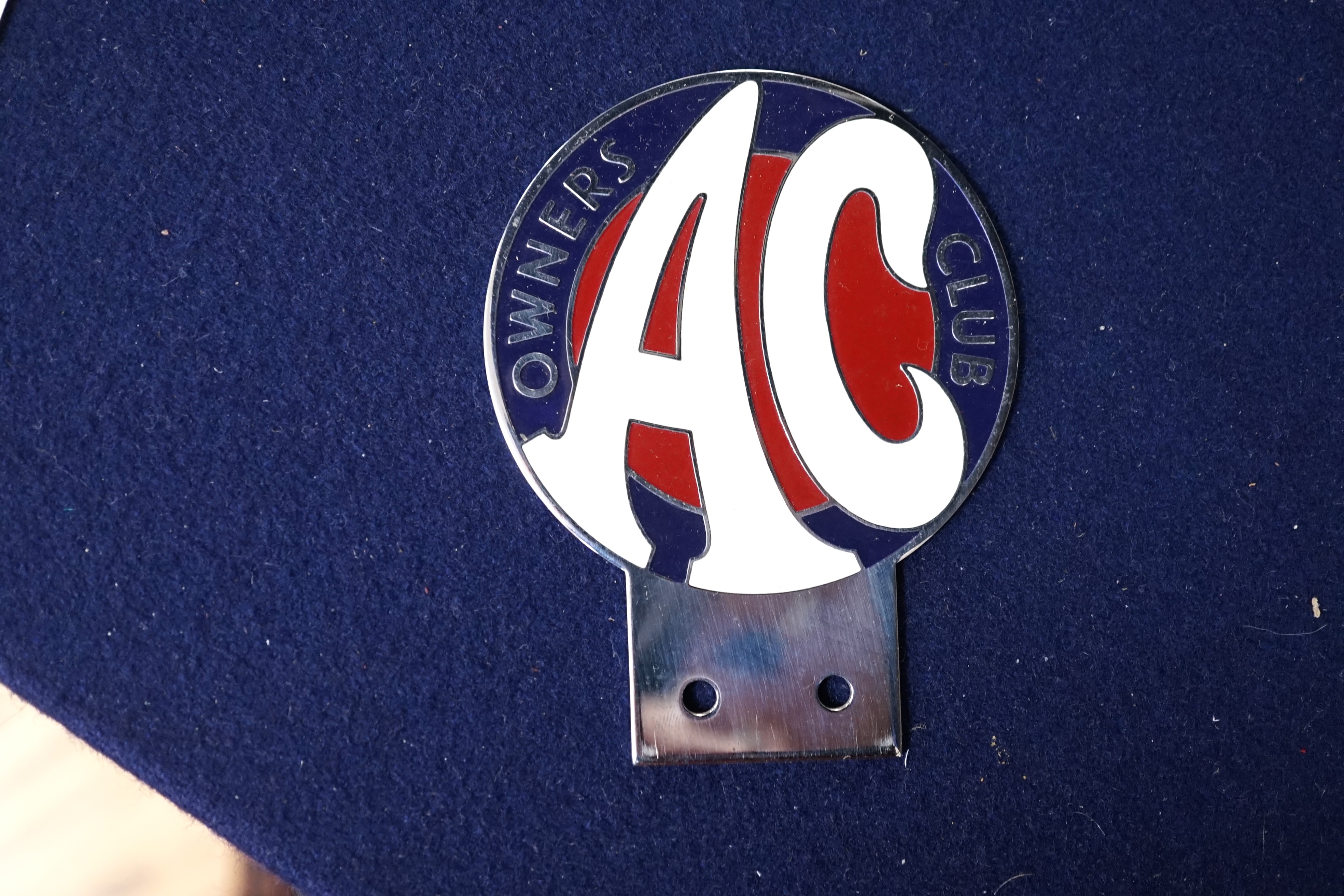 Automobilia interest; an Elva Courier car badge, a Goodwood B.A.R.C.1965 badge no.1135, three M.M.C (mouse badges and a WL.O.C badge and an AC Owners Club mascot badge. Condition - fair to good.